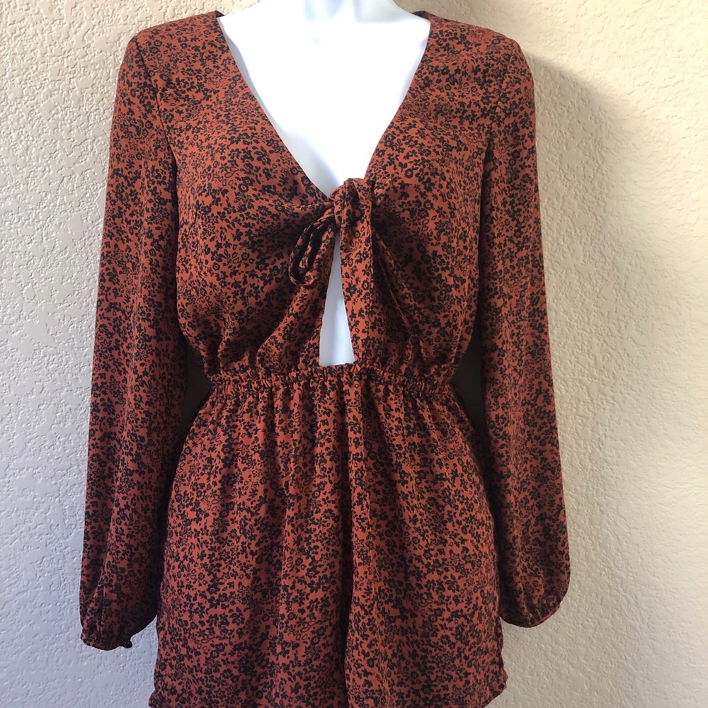 Long sleeve floral dark brown romper.